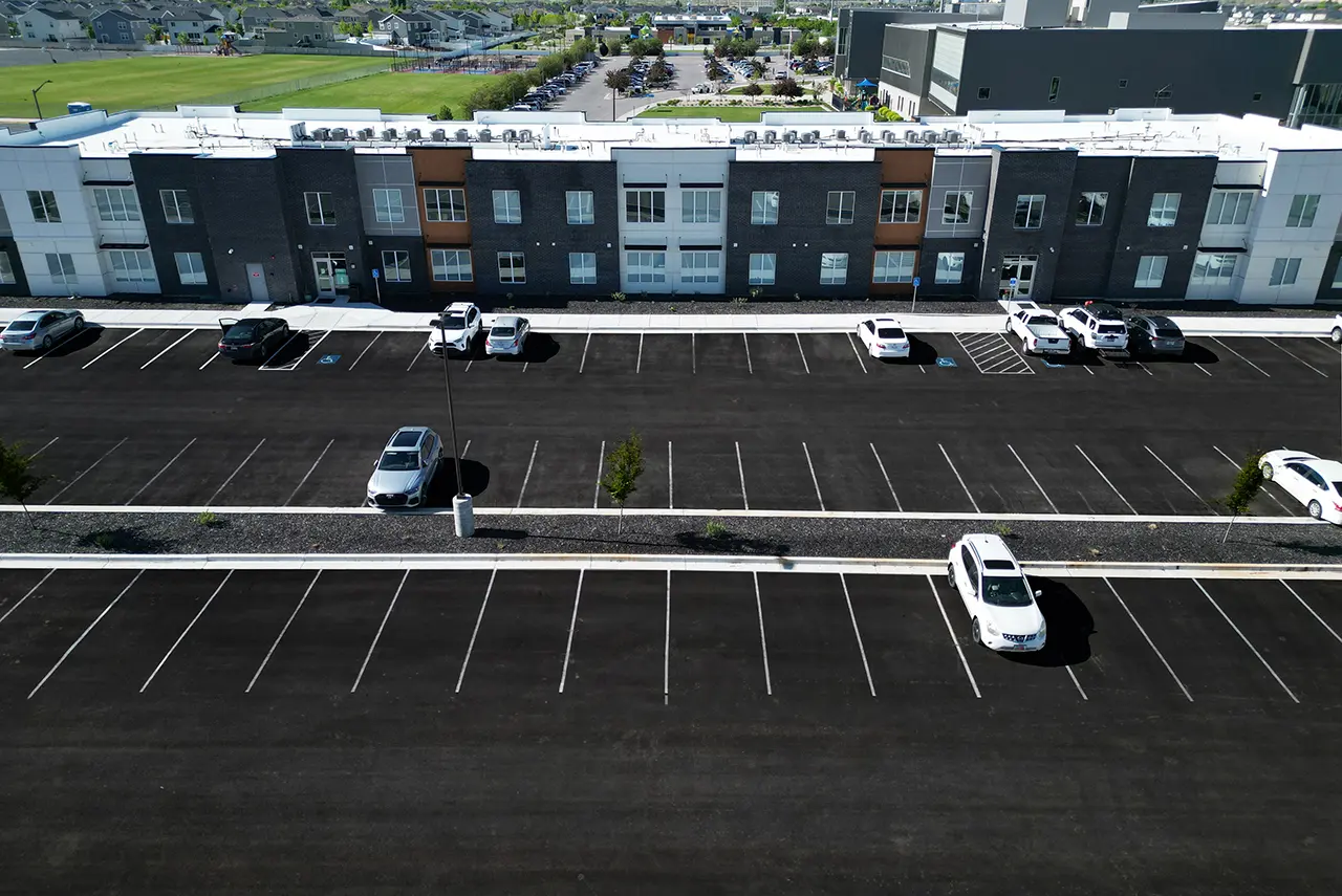 Aerial view of Gallery Apartments with spacious on-site parking and nearby neighborhood amenities.
