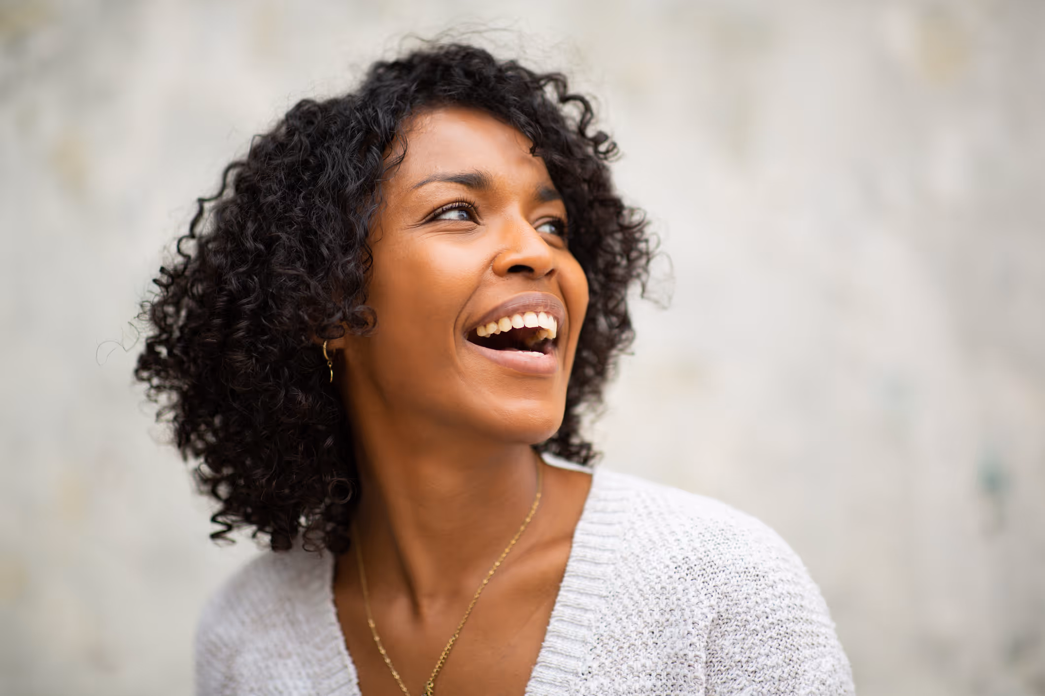 Smiling woman outdoors, confidently representing Hormone Therapy success.