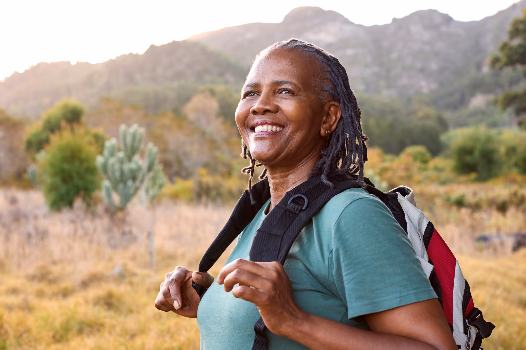 Smiling woman outdoors, confidently representing Hormone Therapy success.