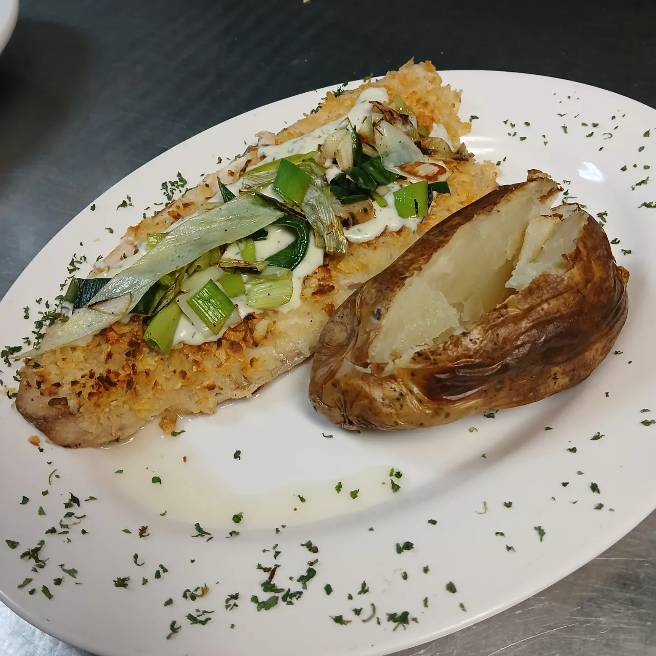White fish plate with oven potato