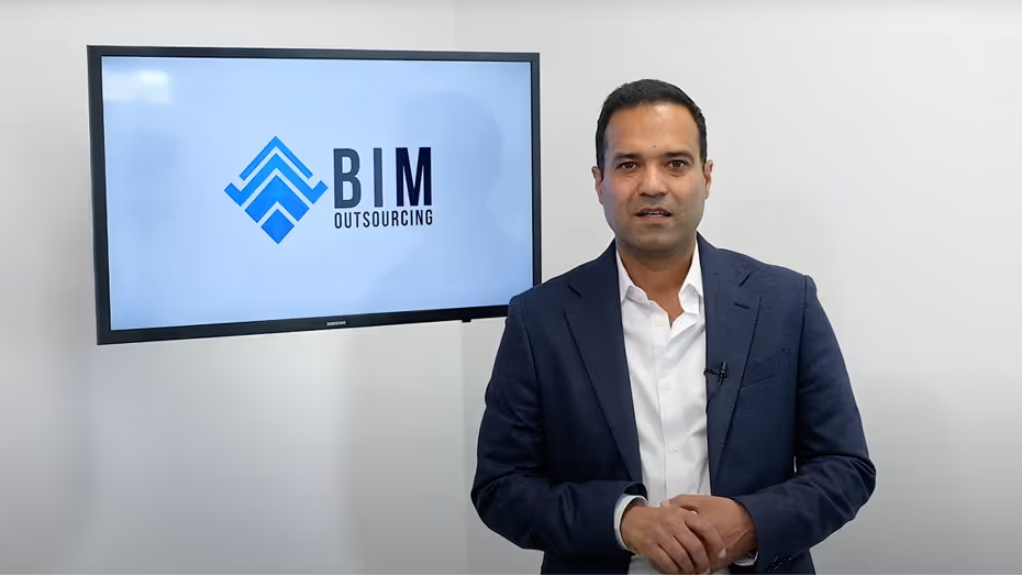 Man in a dark suit and white shirt standing next to a screen displaying the BIM Outsourcing logo on a white background.