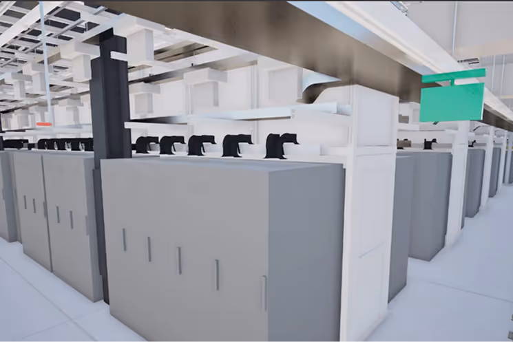 Interior view of a data center aisle with multiple gray server racks and overhead cable management.