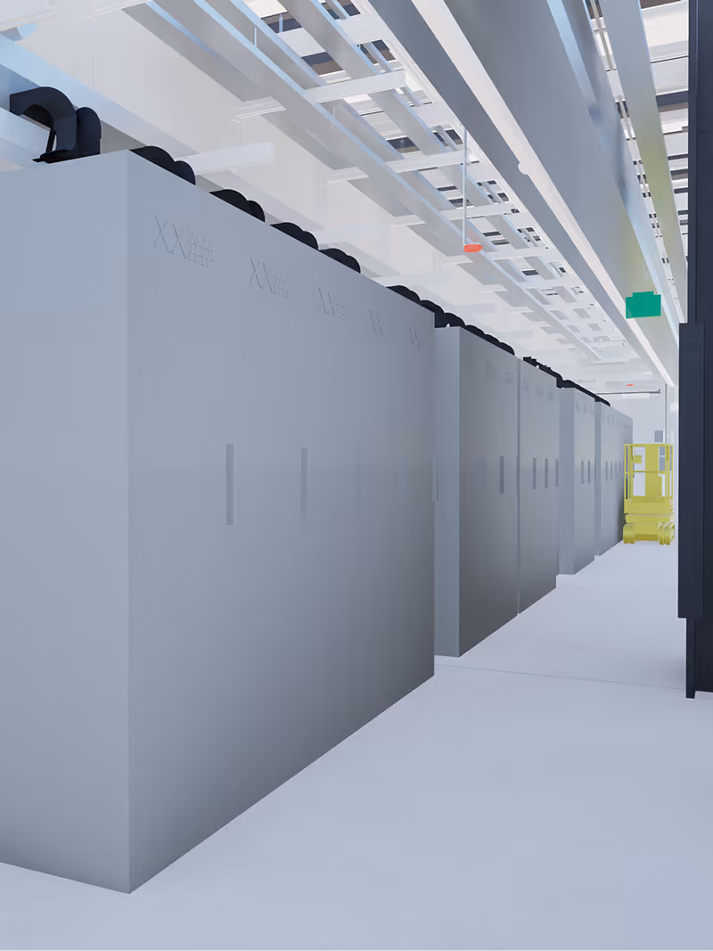 Long row of large industrial data center cooling units under white ceiling pipes and conduits.