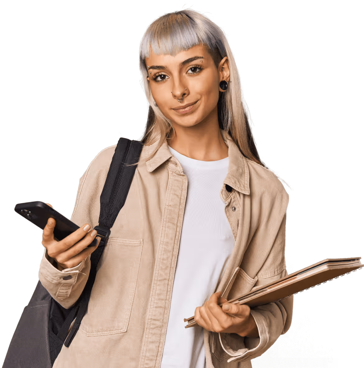 Young person with dyed light hair, wearing a beige jacket and white shirt, holding a smartphone and notebooks with a backpack strap over one shoulder.