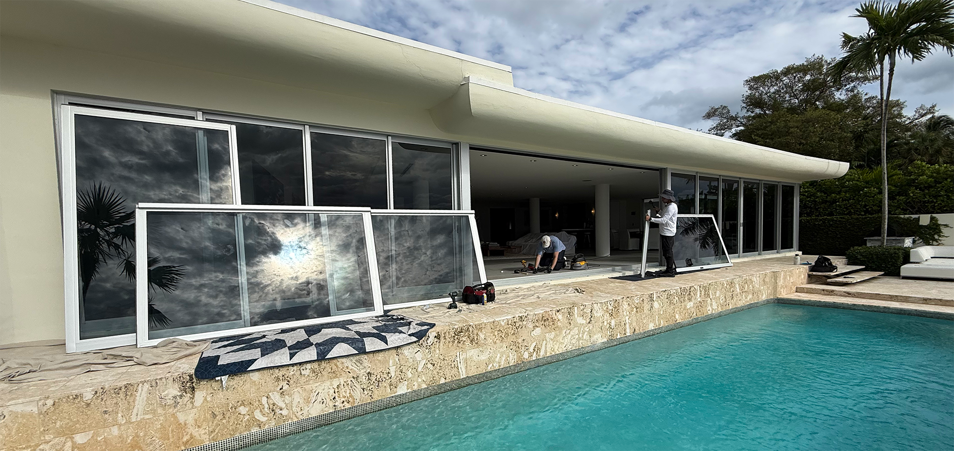 A picture of an Eastway Sliding Doors worker replacing big sliding windows at a client's house