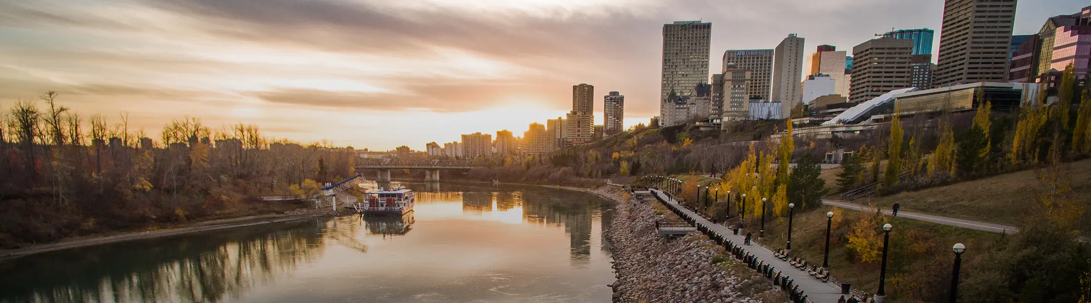 Edmonton at sunset with riverboat on the river and downtown on the right