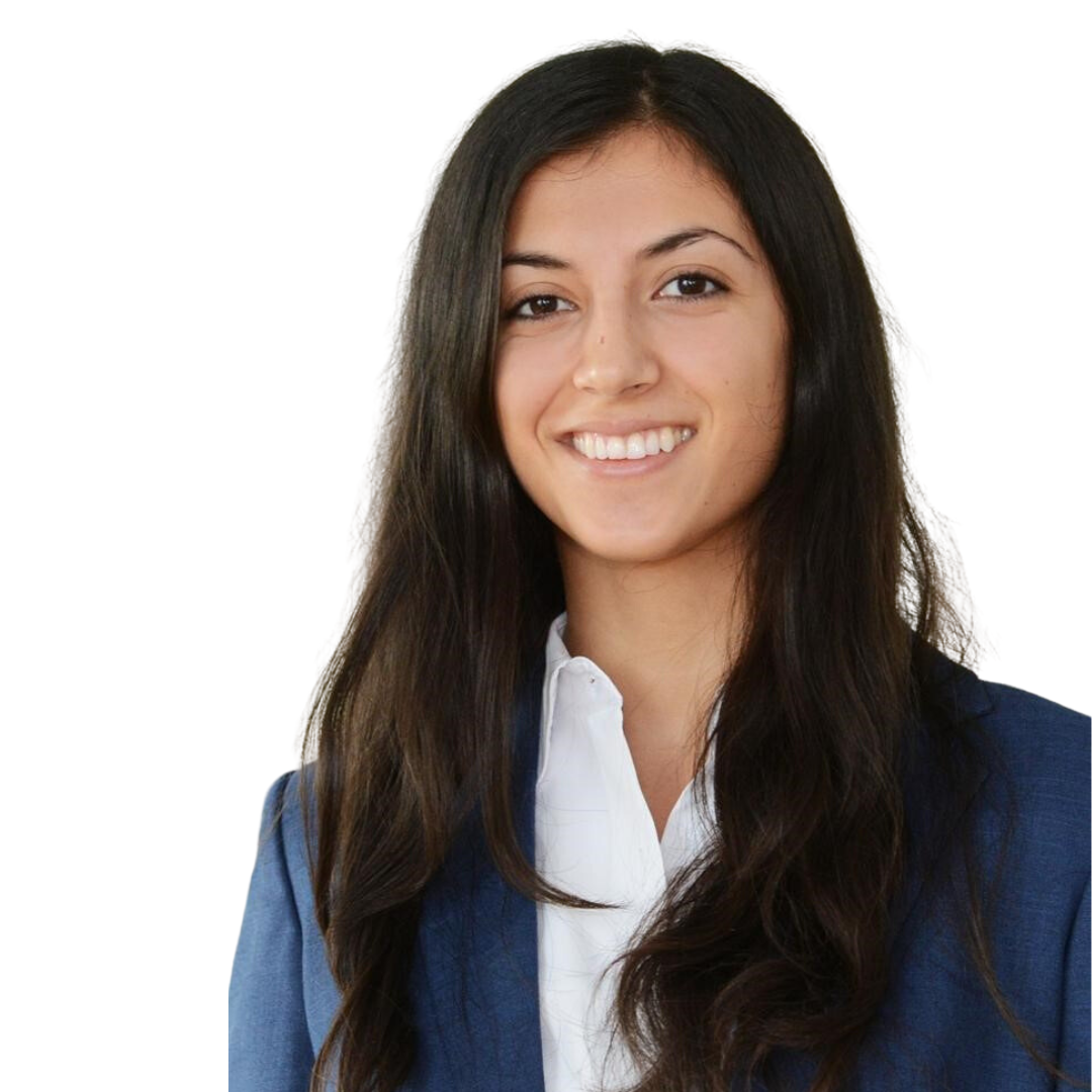 Smiling woman with long dark hair wearing a white shirt and blue blazer against a white background.