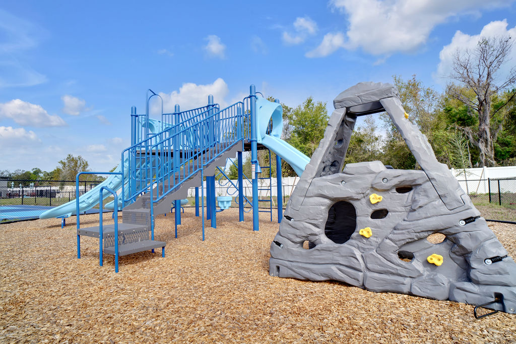 Playground with blue side a rock climbing wall