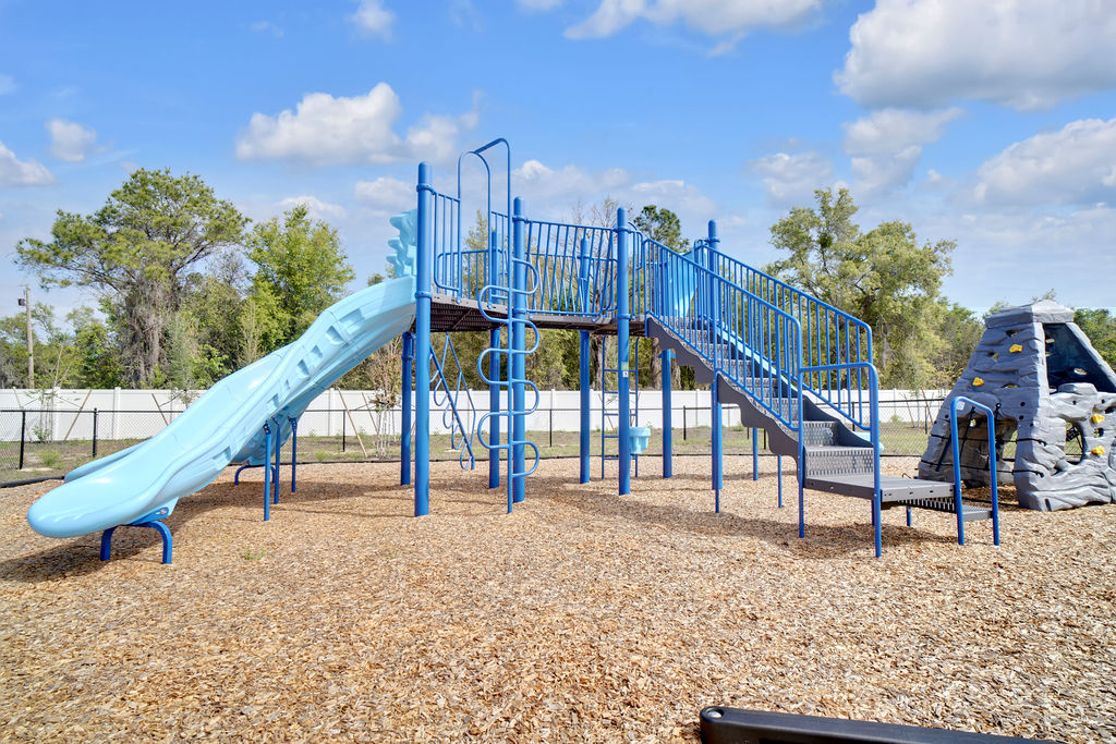 Kids playground with slide and rock climbing wall