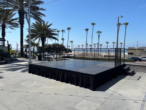 16 x 16 Steel Deck Stage with skirt, safety rail and stairs.