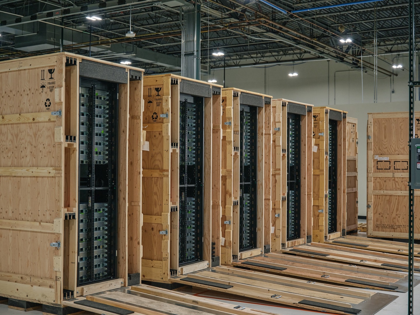 Six crated Oxide racks lined up on a warehouse floor
