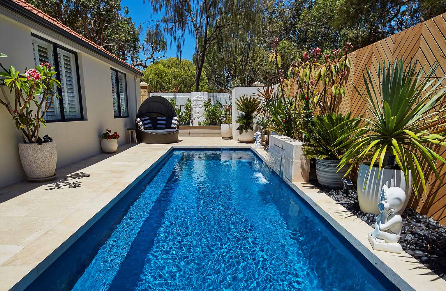 Heron narrow fibreglass pool with tropical planting and poolside cabana