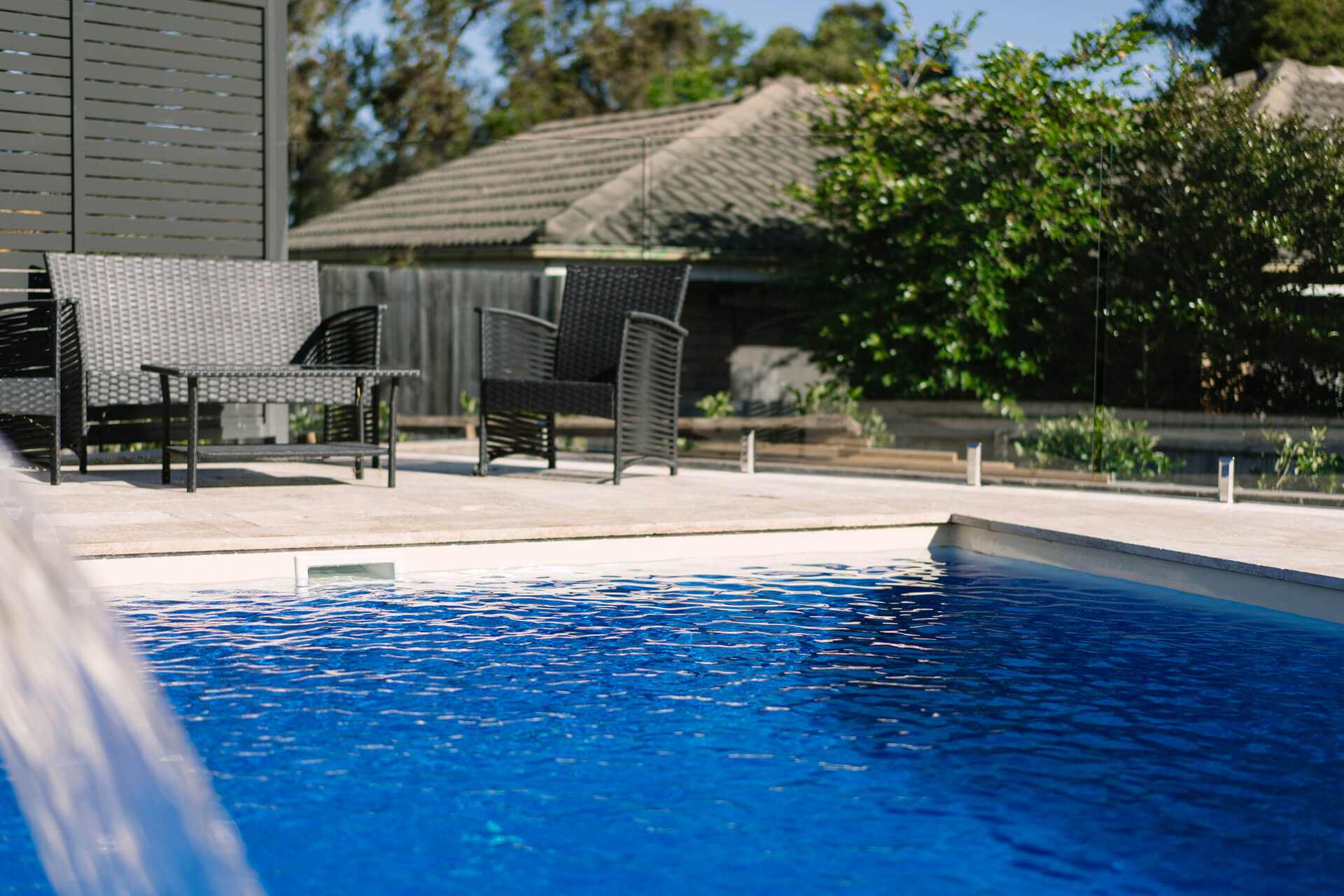 Beach 7 fibreglass pool with outdoor furniture in a Sydney backyard