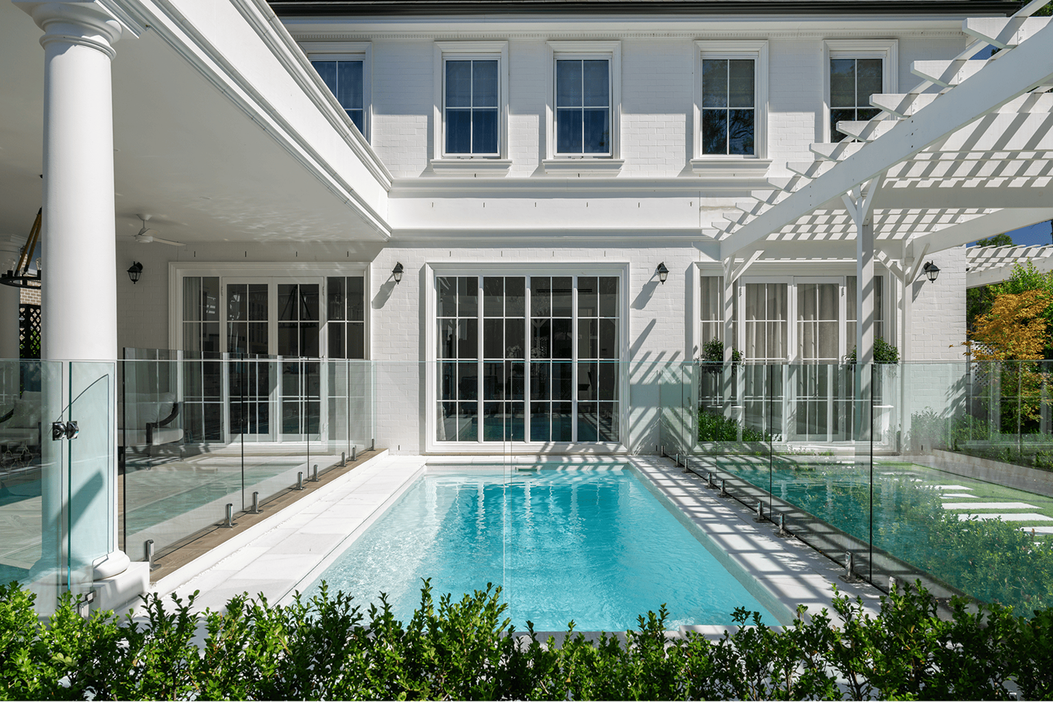 Hamptons-style home with a fibreglass pool and glass fencing