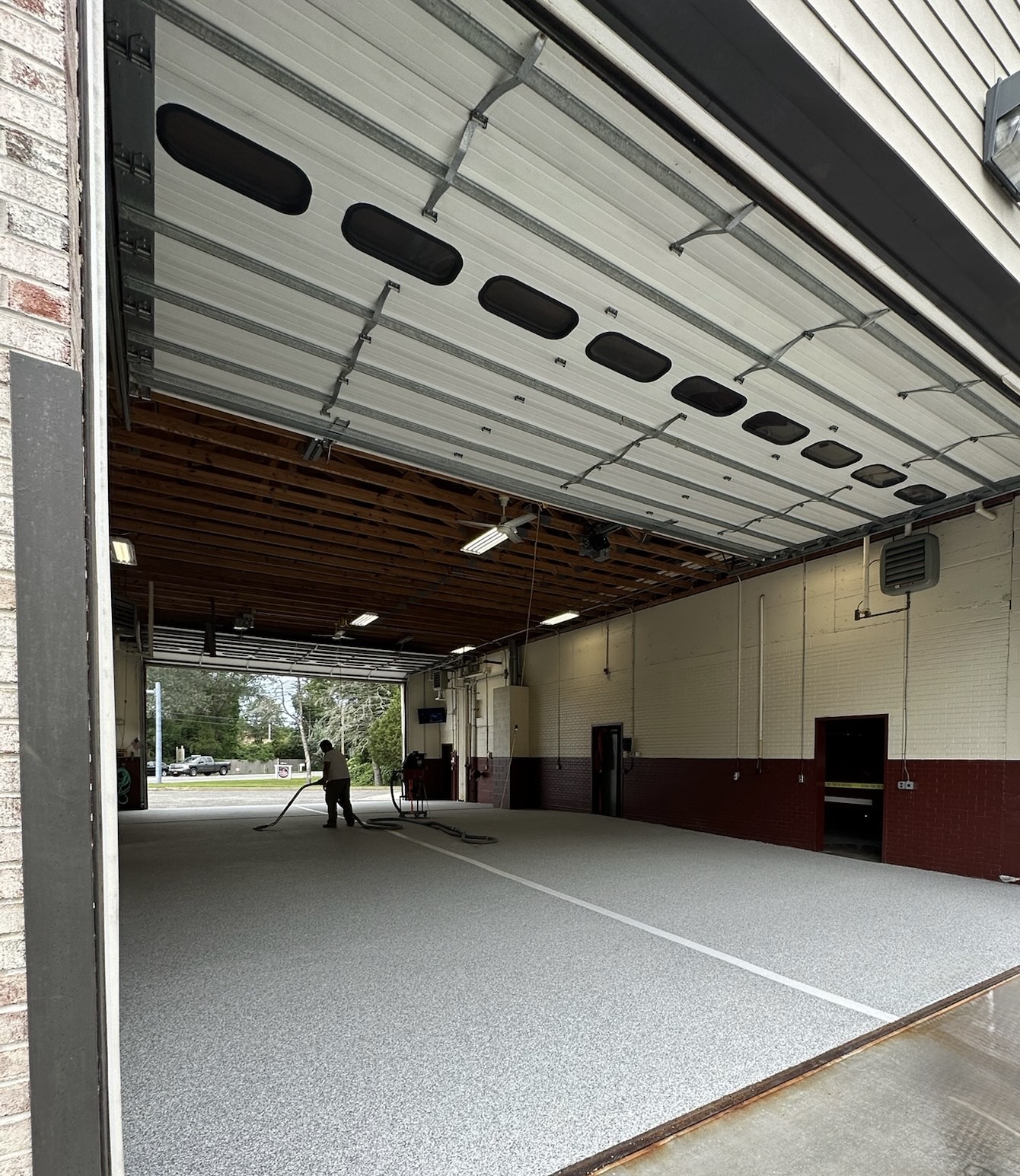 image of a man finishing epoxy flooring at a firehouse