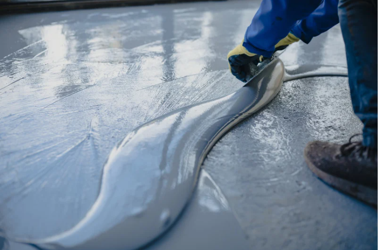 image of a person installing epoxy flooring