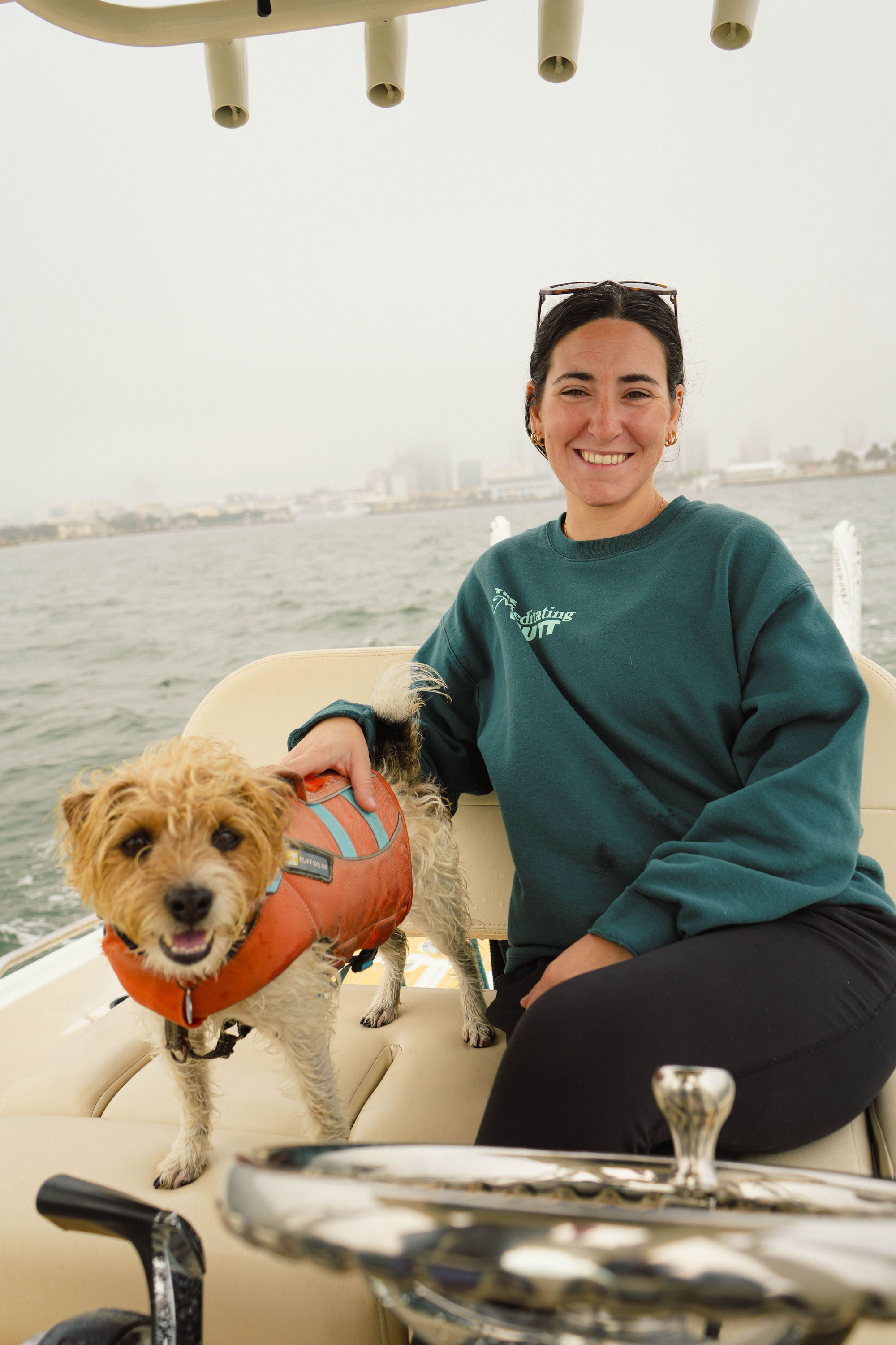 Dog trainer assisting a St. Pete Beach family with gentle, relationship-based training