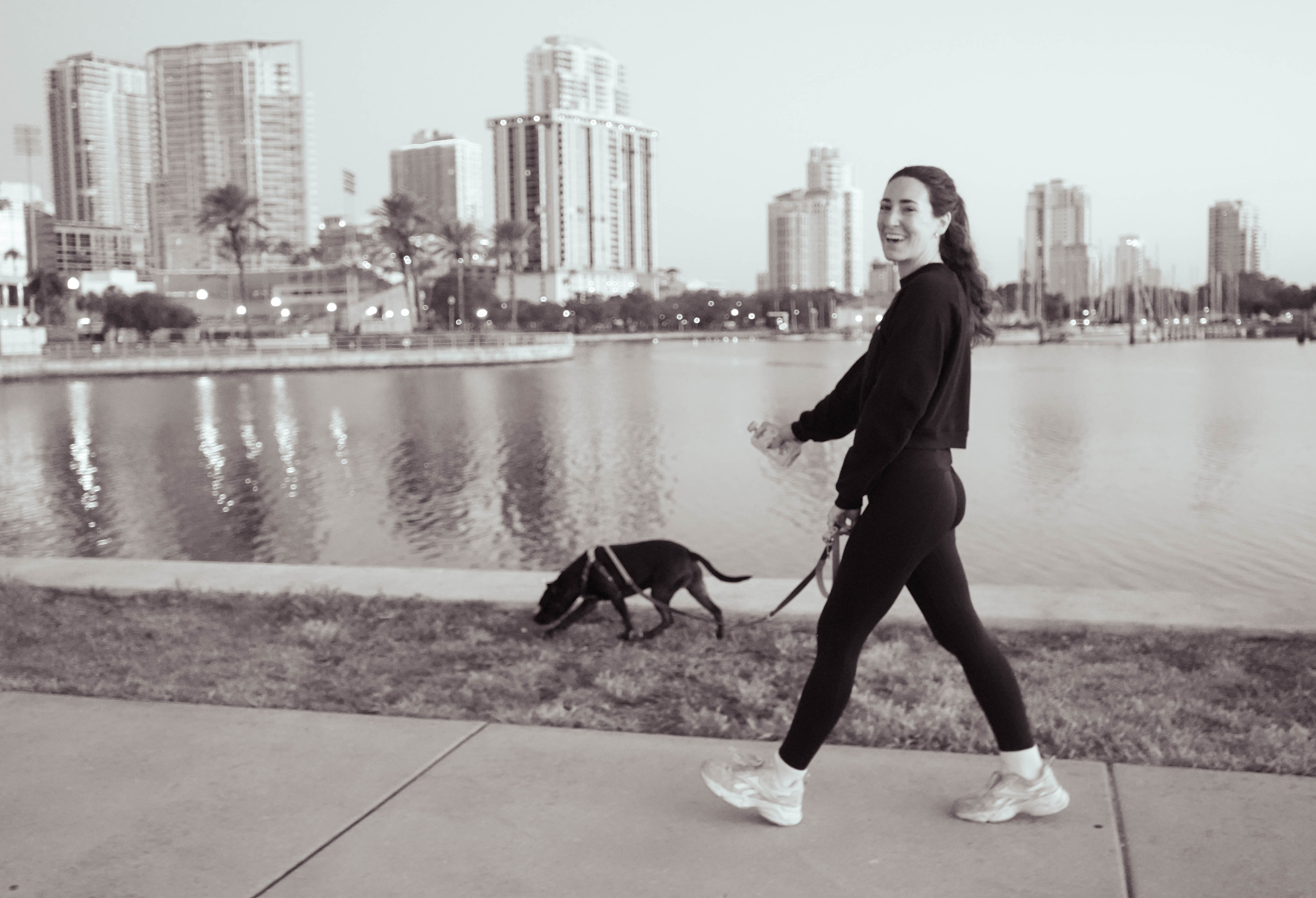 Holistic dog trainer guiding a dog owner in St. Petersburg with calm, supportive coaching