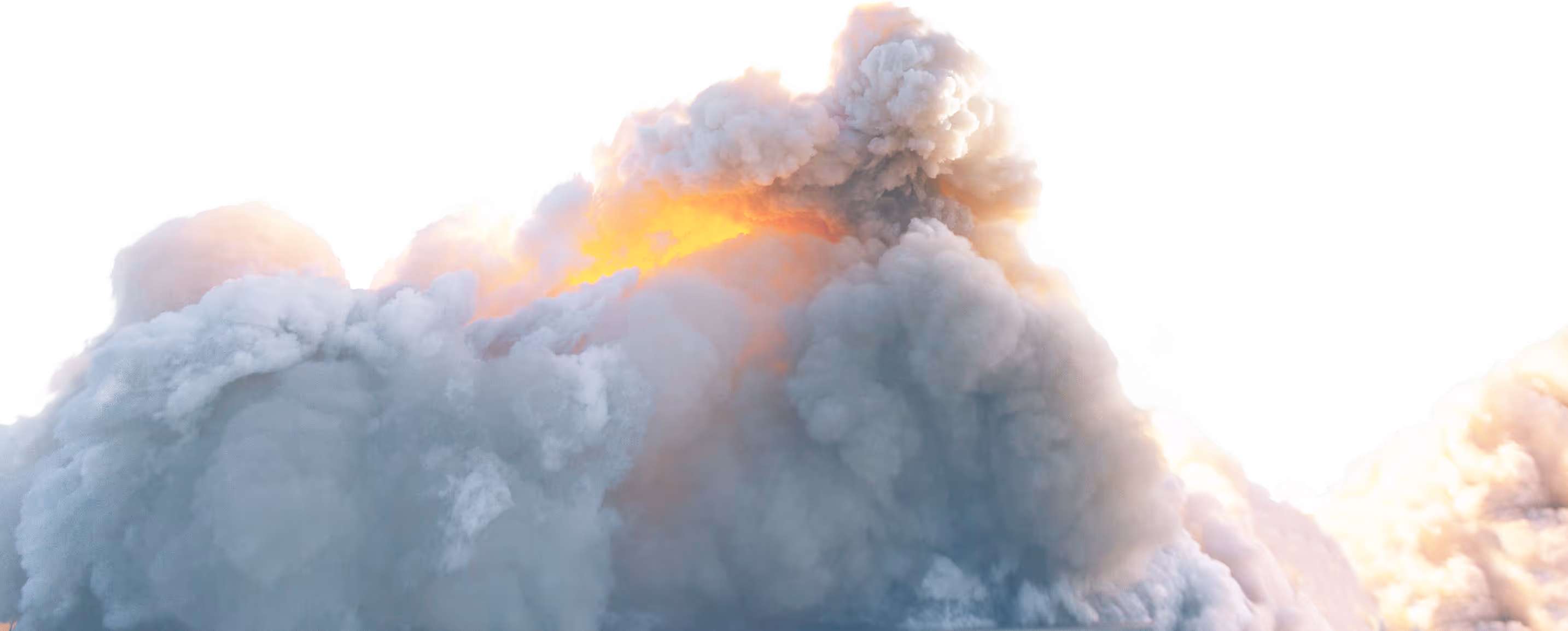 A large cloud of smoke and steam rising from the top of a building.