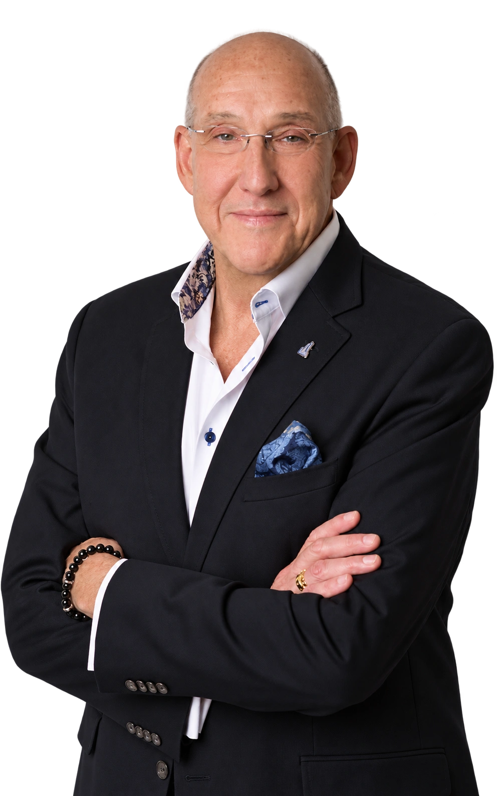 Drew McManigle of MACCO Group in Houston, Texas, wearing a black blazer with his arms crossed.