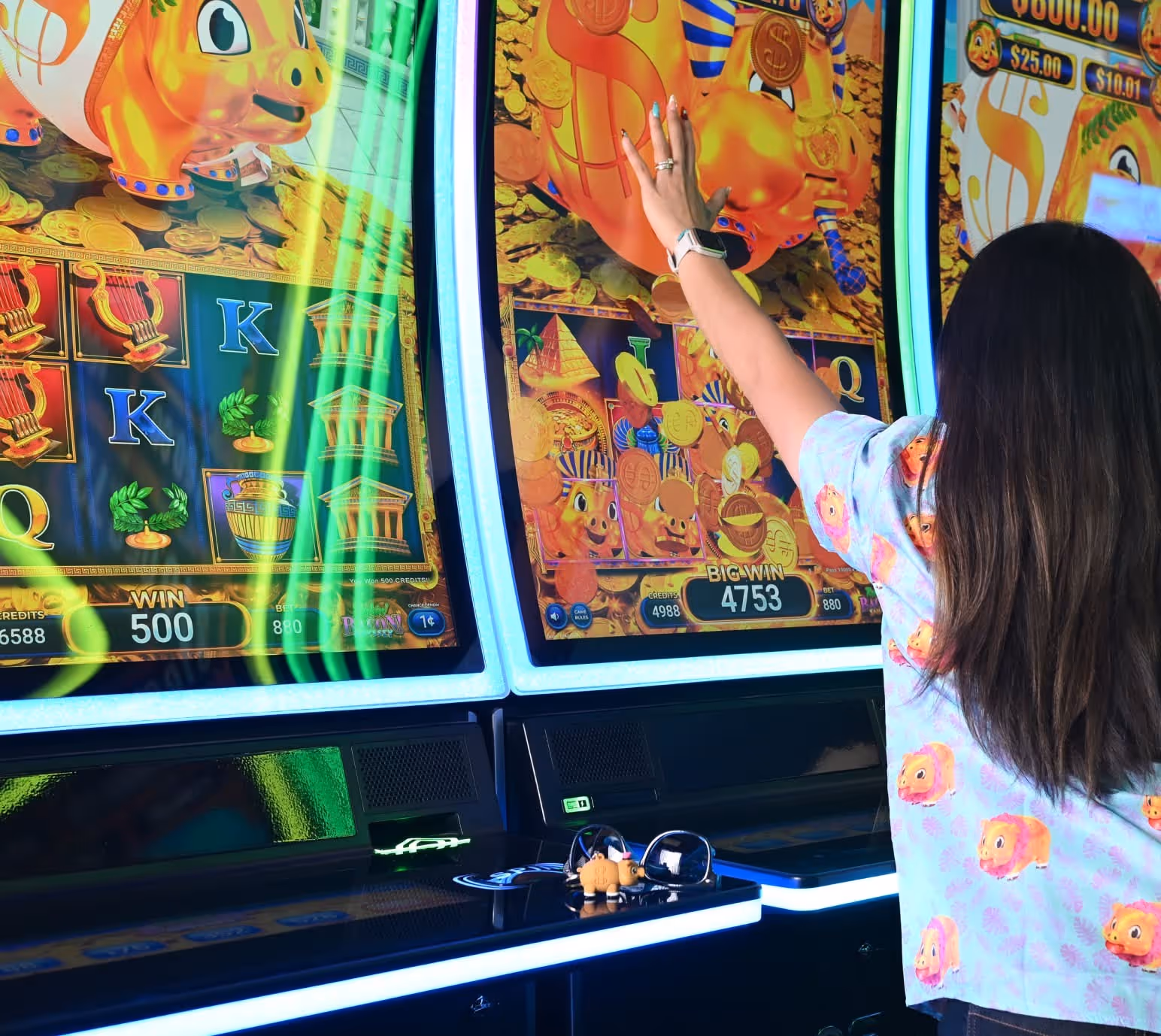 Person playing colorful slot machine with cartoon characters and coins