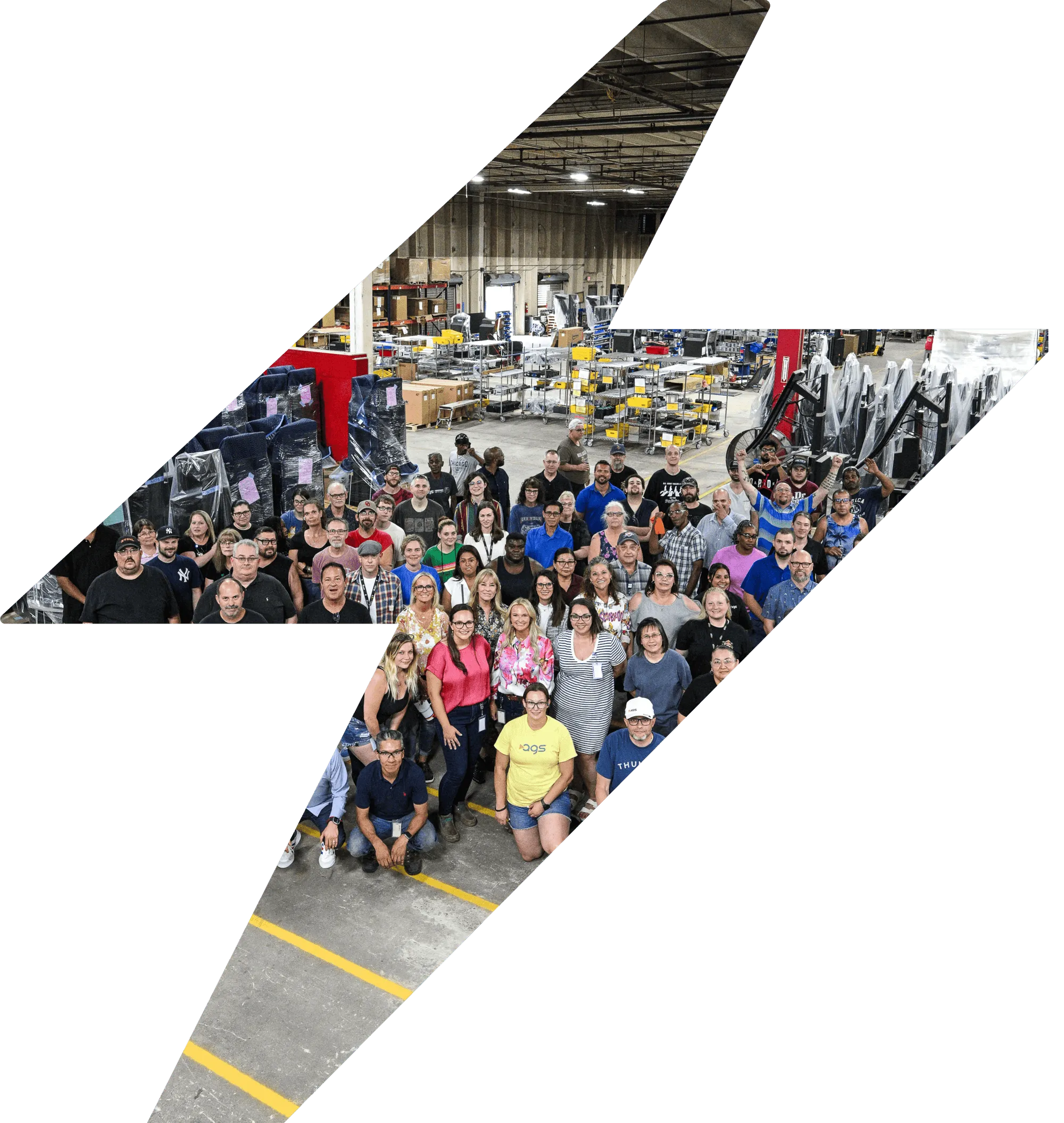AGS team photo in manufacturing facility with diverse workforce