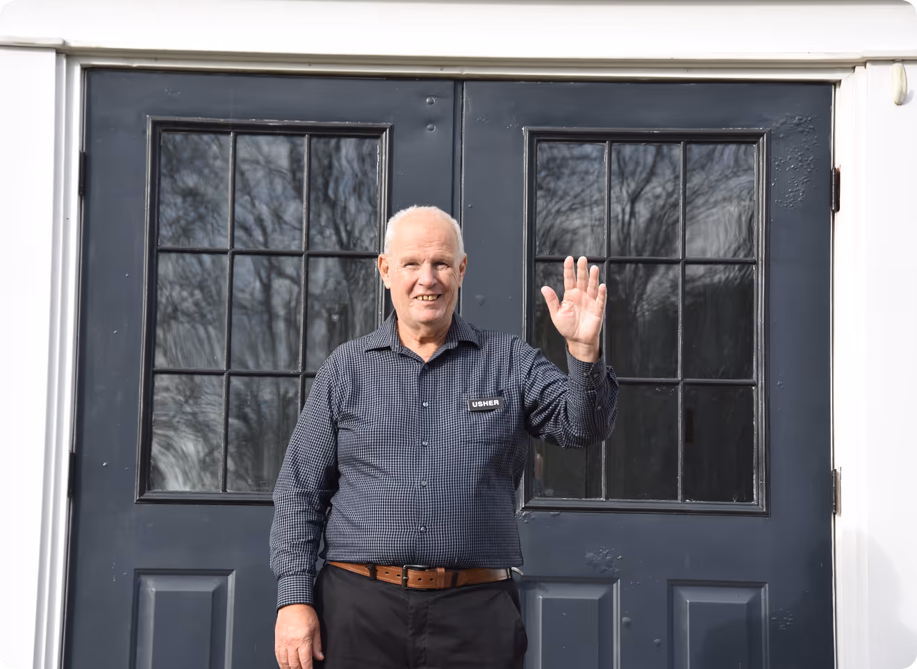 Image of an usher at Abundant Life Church waving