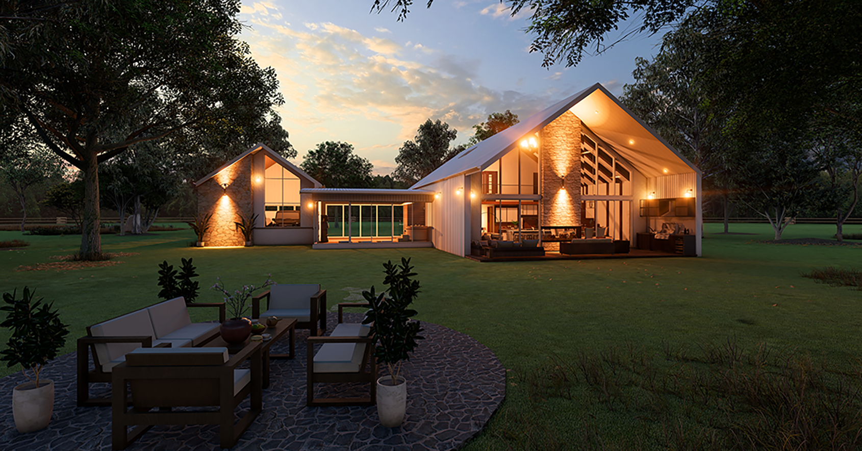 Modern two-story house at dusk with warm exterior lighting, large windows, and outdoor seating area on a stone patio surrounded by grass and trees.