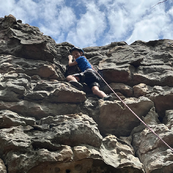 boy rock climbing