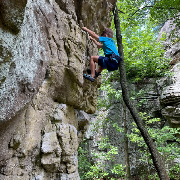 boy rock climbing