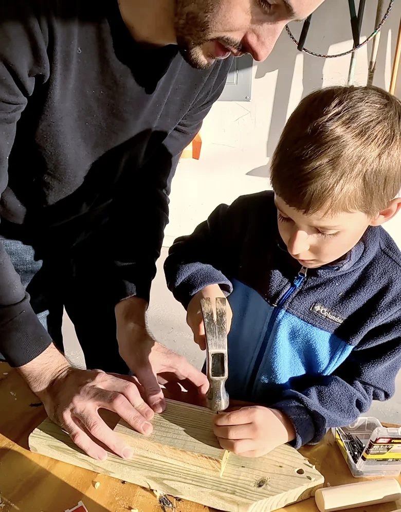 Boy and dad build project in garage