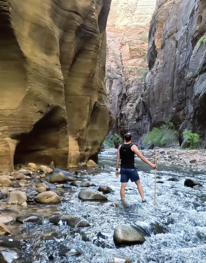 Man stands in Narrows at Zion National Park