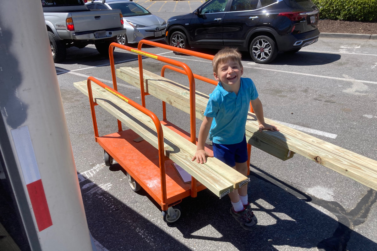 A kid with lumber at home depot