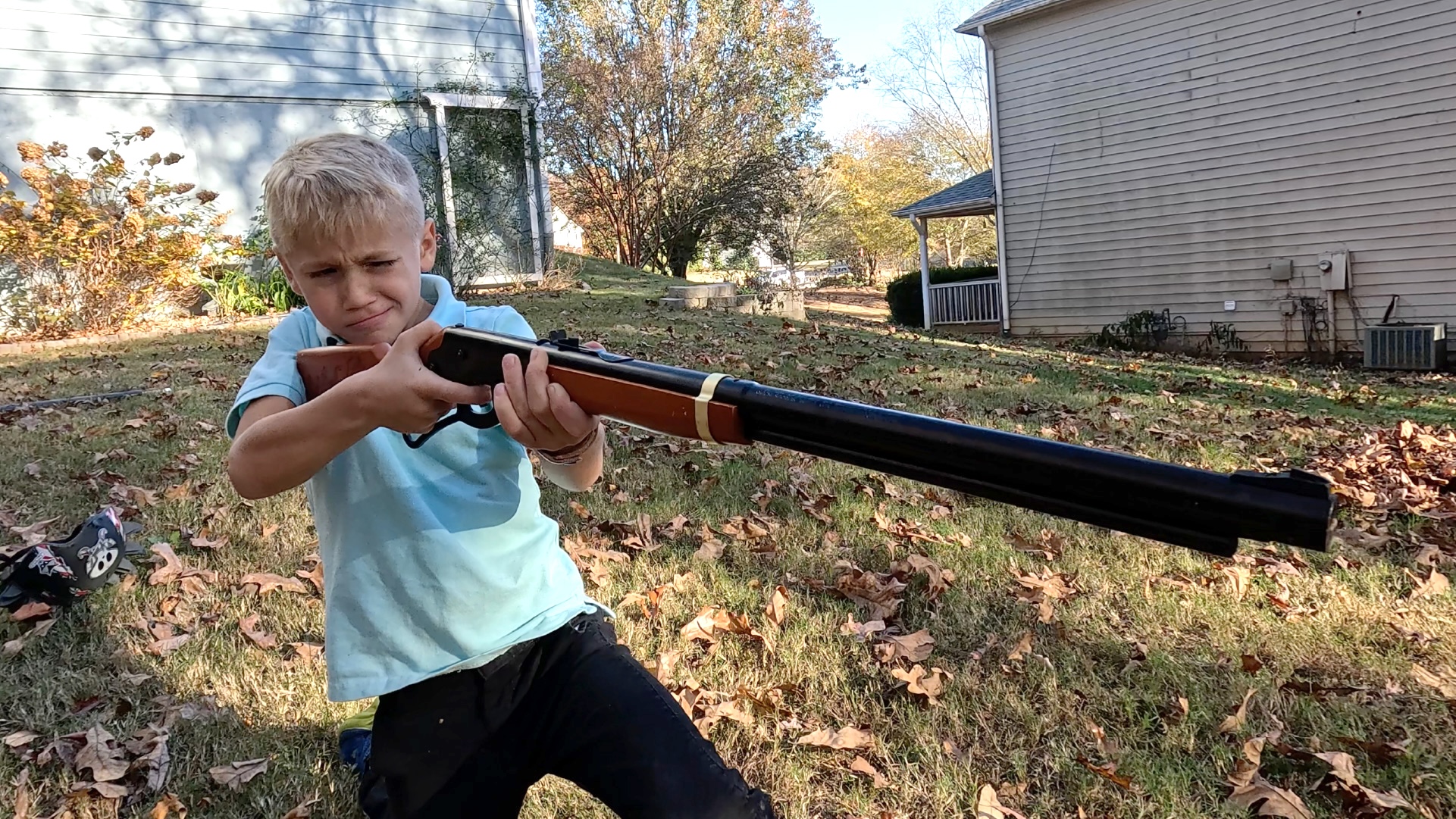 A boy shoots a Red Rider BB gun