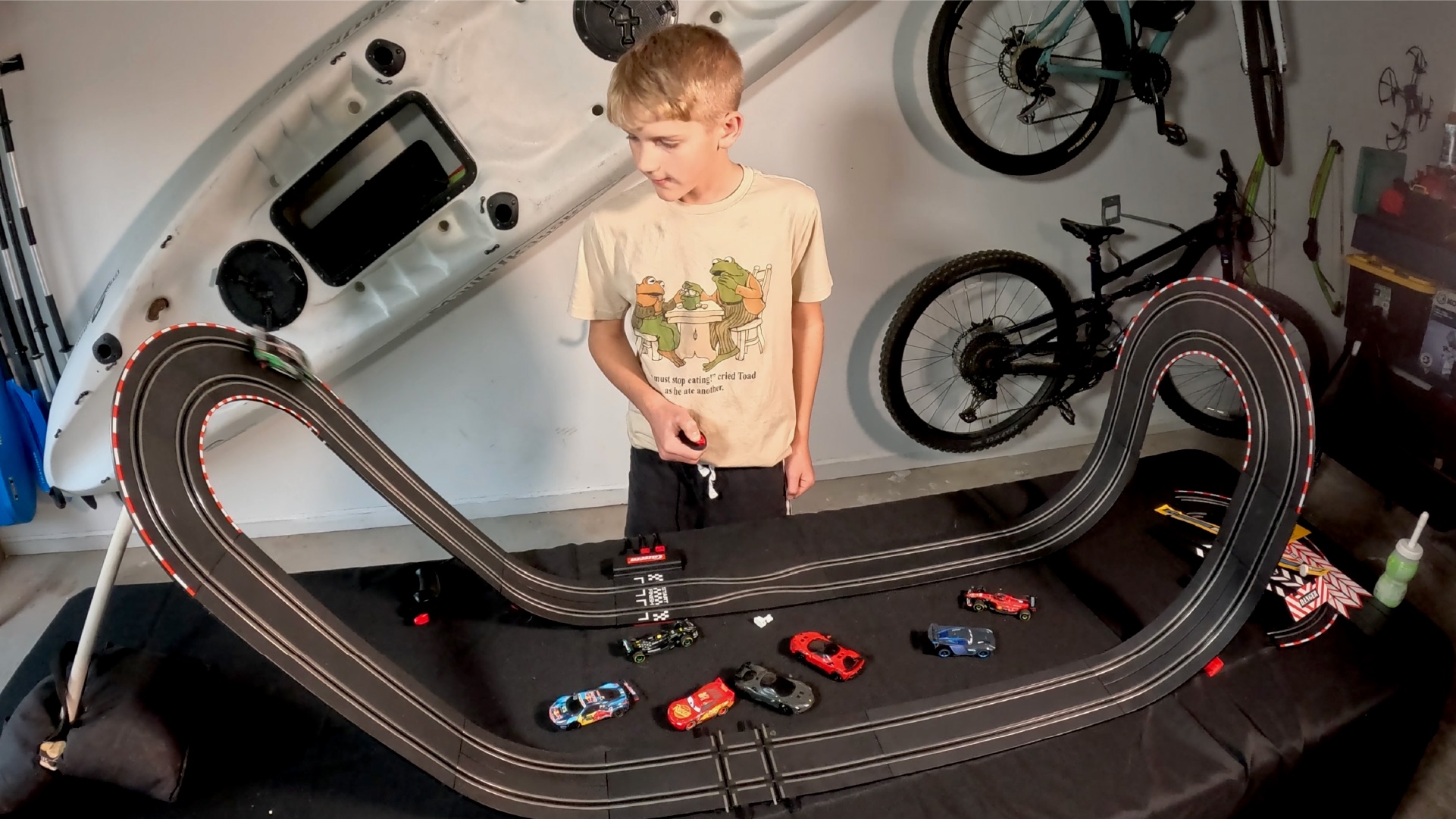 A boy plays with slot cars
