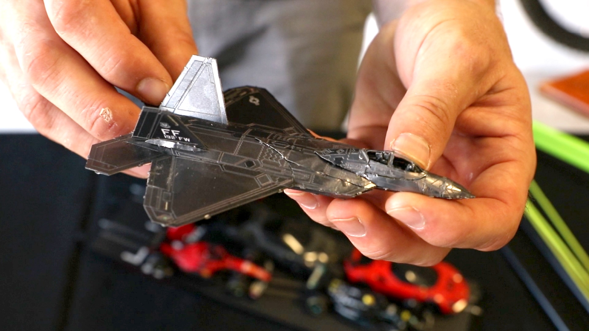 Hands hold an F35 Metal Earth model 