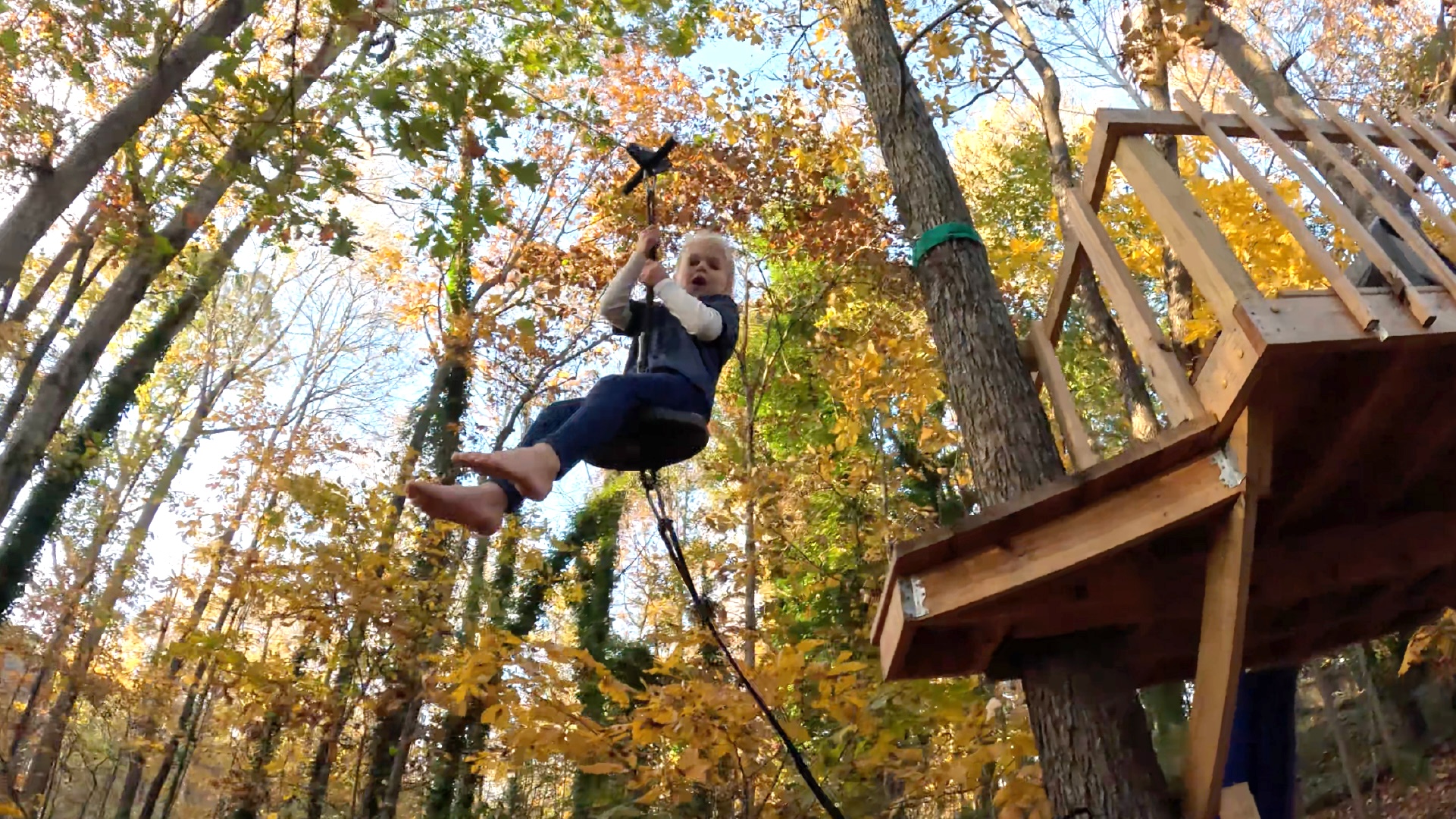 A girl flies down a zip-line