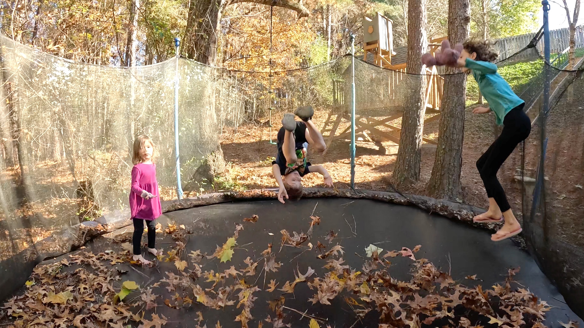 Kids bounce on a trampoline 