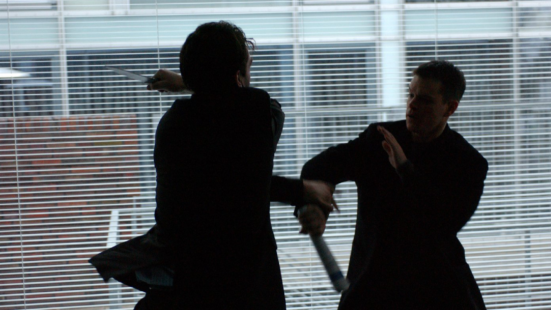 Jason Bourne fights off an attacker with a knife.