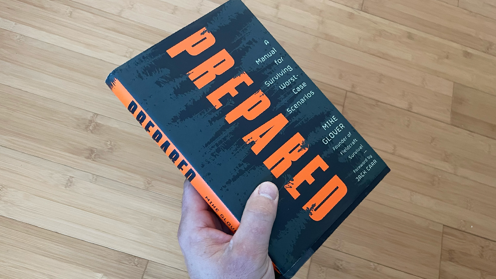 Hand holds a book called "Prepared".