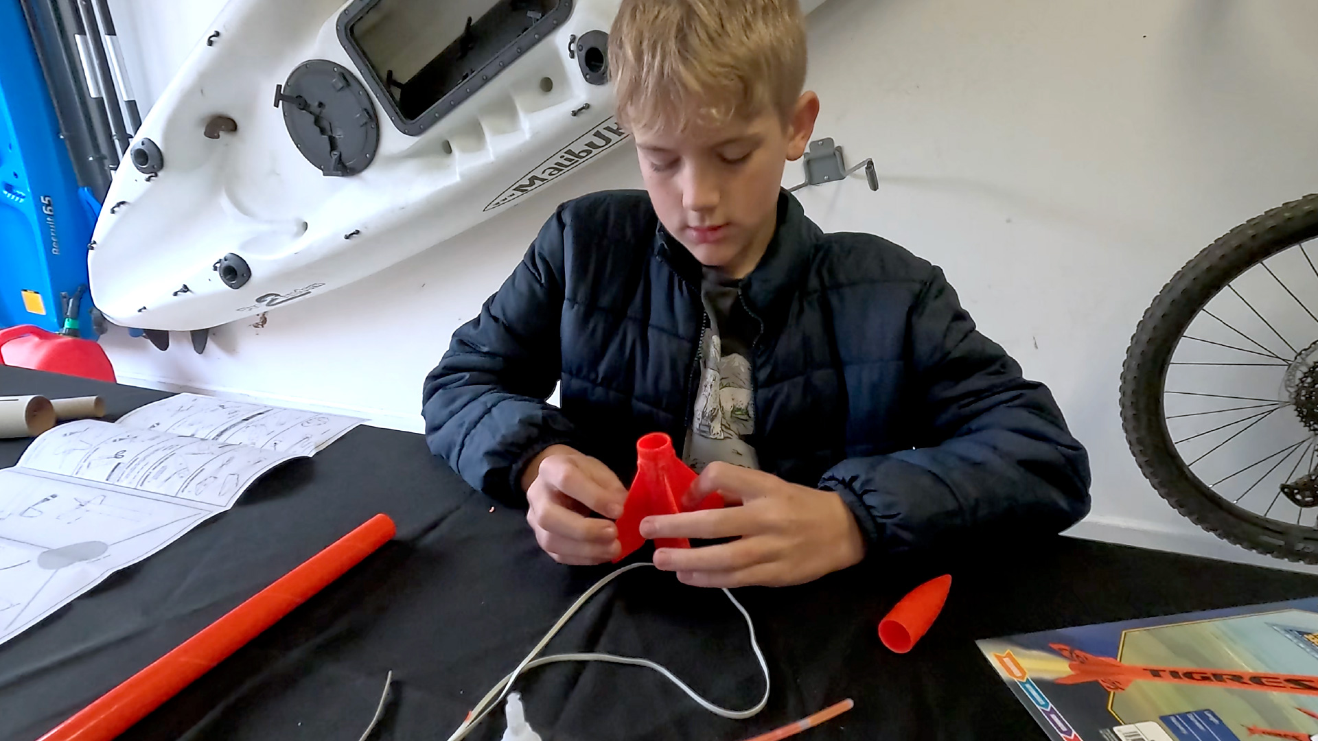 A boy builds an Estes Rocket