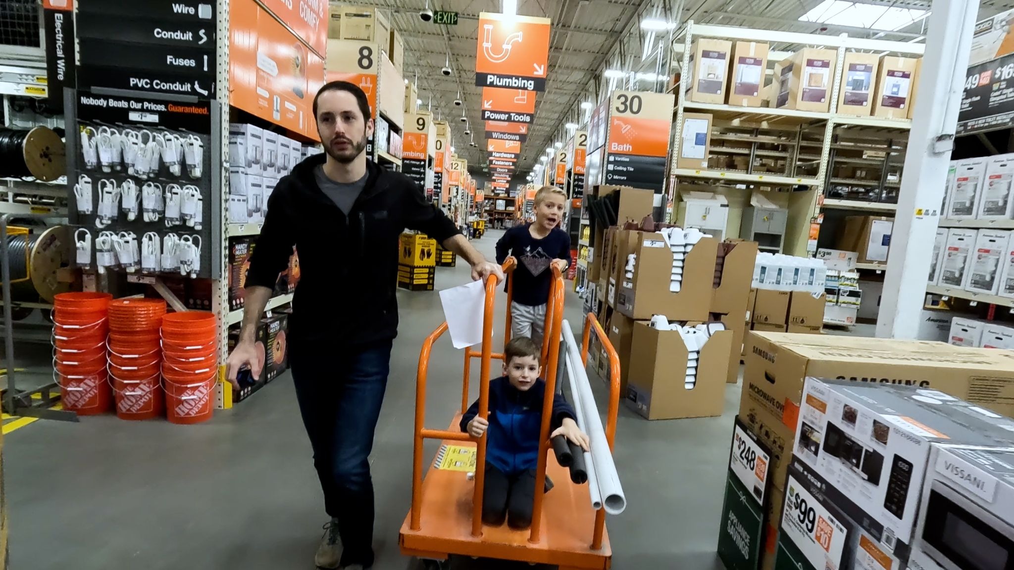 Man walking with kids through Home Depot 