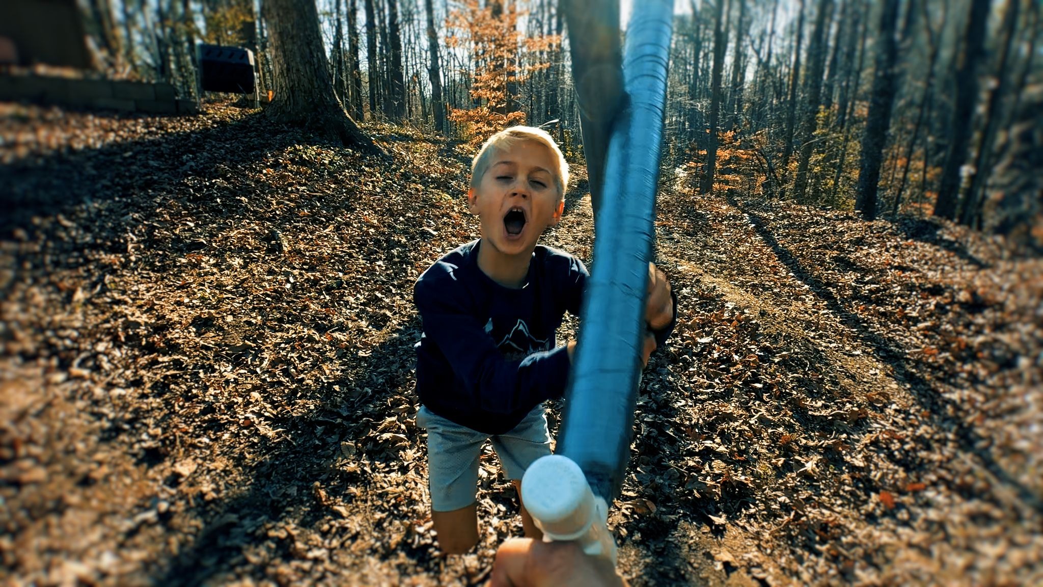 Boy pretend sword fighting