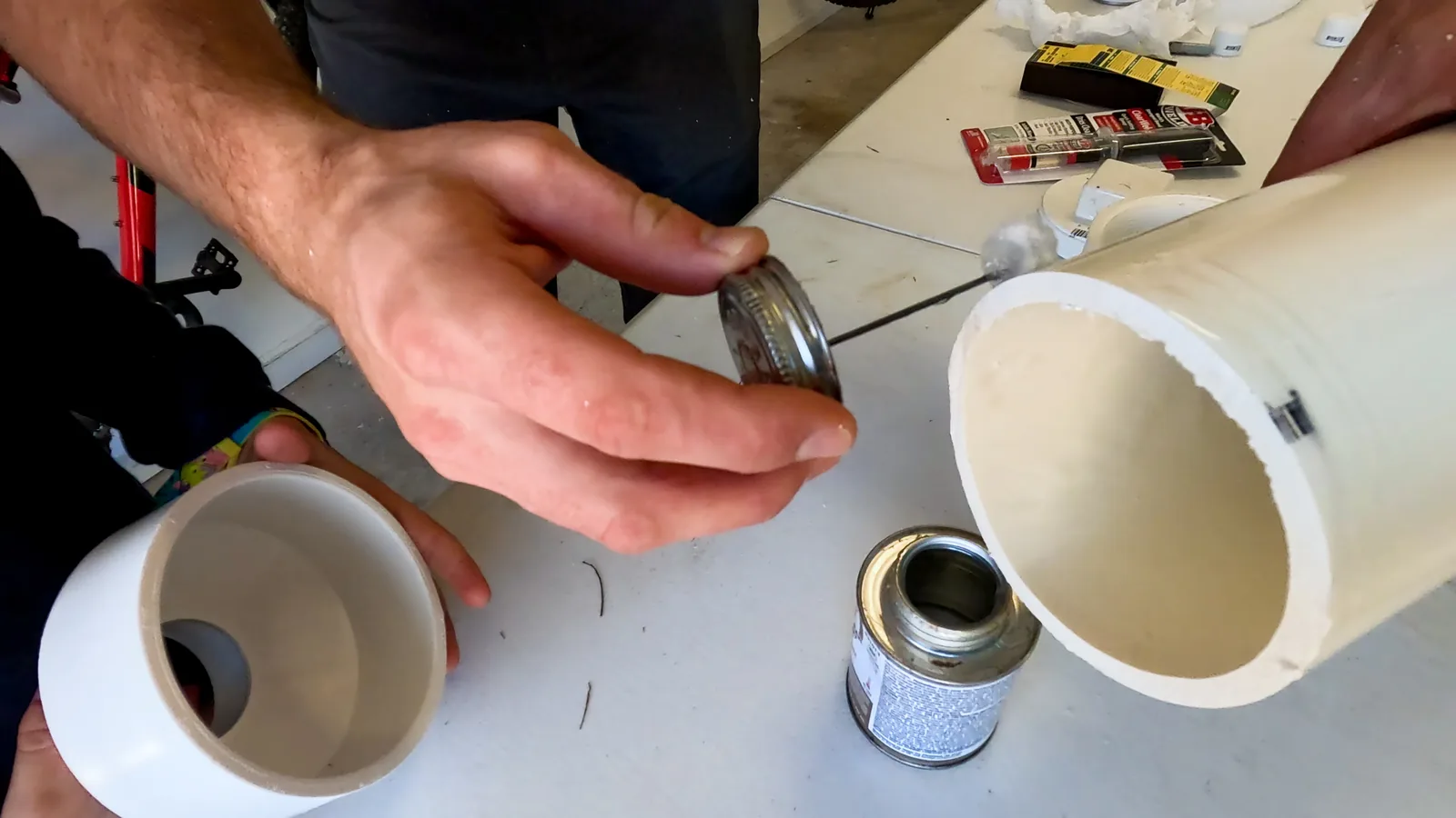 Man glues a PVC pipe