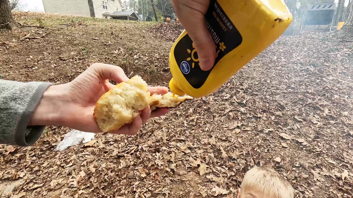 Adding topping to baked bread.