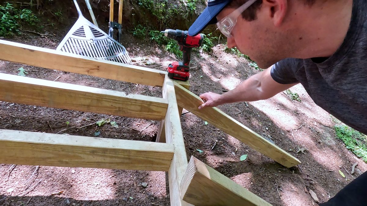 Attach down ramp supports to frame
