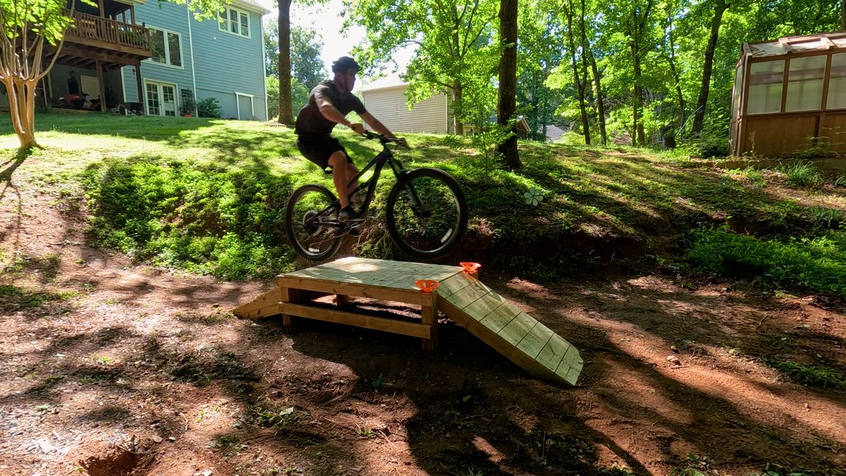 Bike jumping over table top ramp