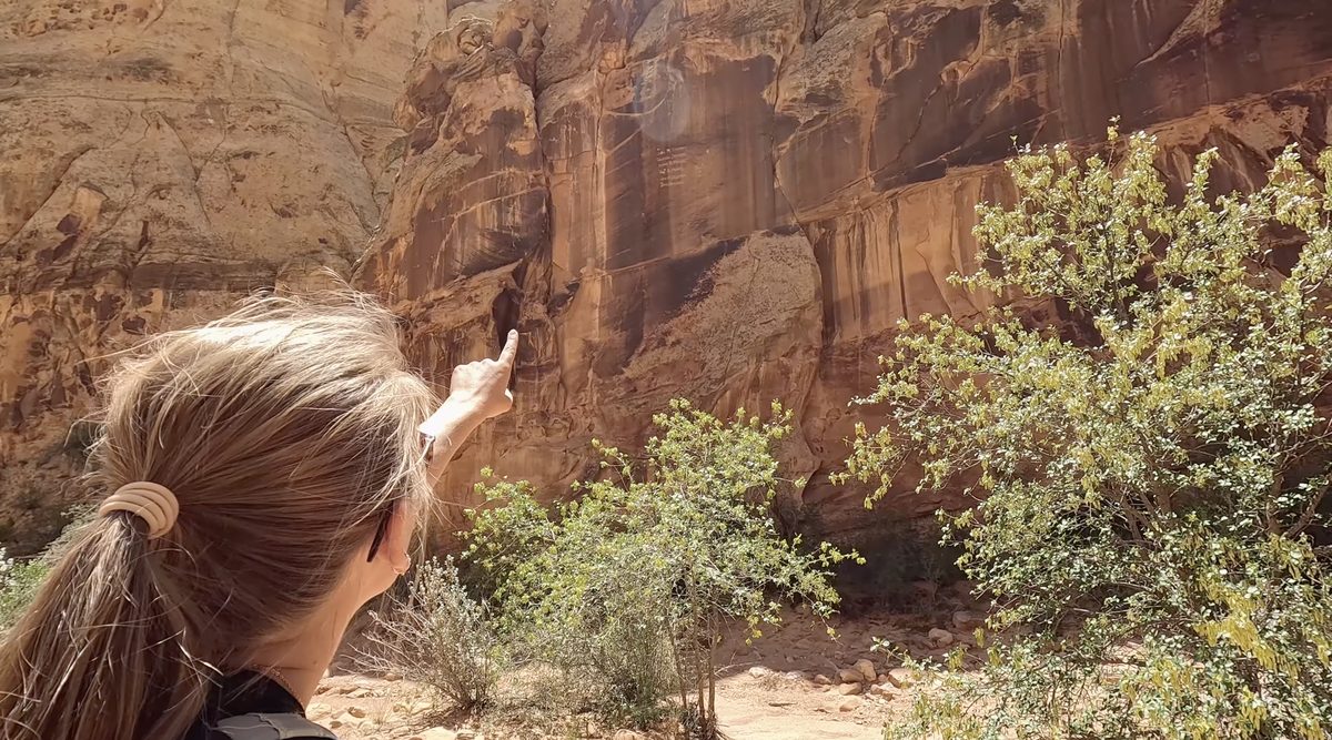 Looking at the Pioneer Register along Capitol Gorge Trail