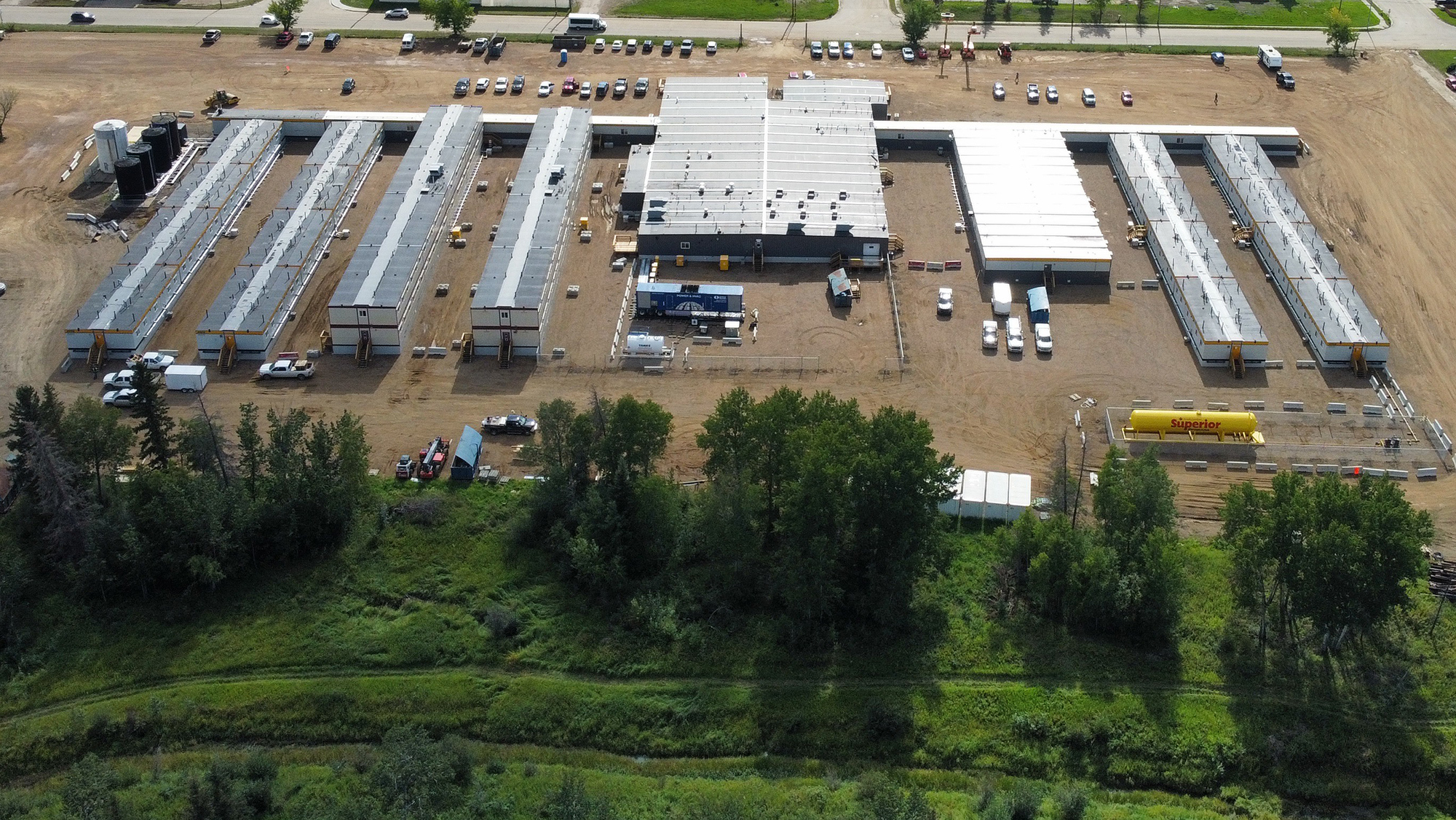 Aerial view of large modular construction site with multiple installed building units
