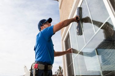 Man cleaning the exterior of a window